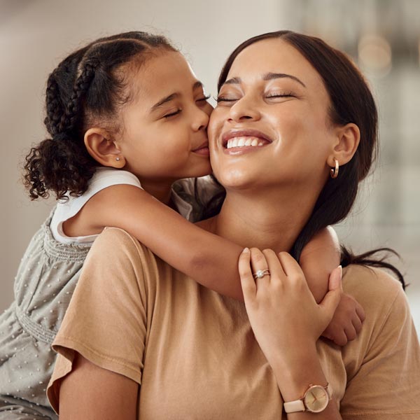 mother and young daughter smiling